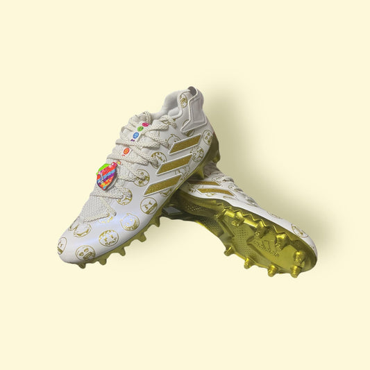 Zapatillas de béisbol Freak 22 Big Mood DSG SM en dorado, con suela de tacos moldeados, diseñadas para máximo rendimiento y un estilo llamativo en el campo