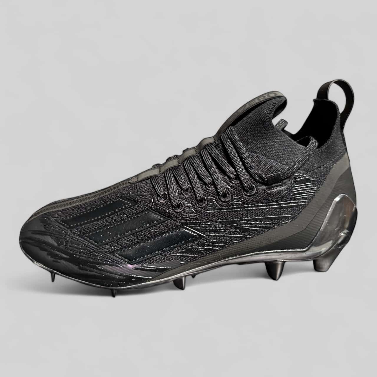 Zapato Adidas Adizero Primeknit negro, con tejido flexible y suela metálica, ideal para velocidad y tracción en el béisbol.