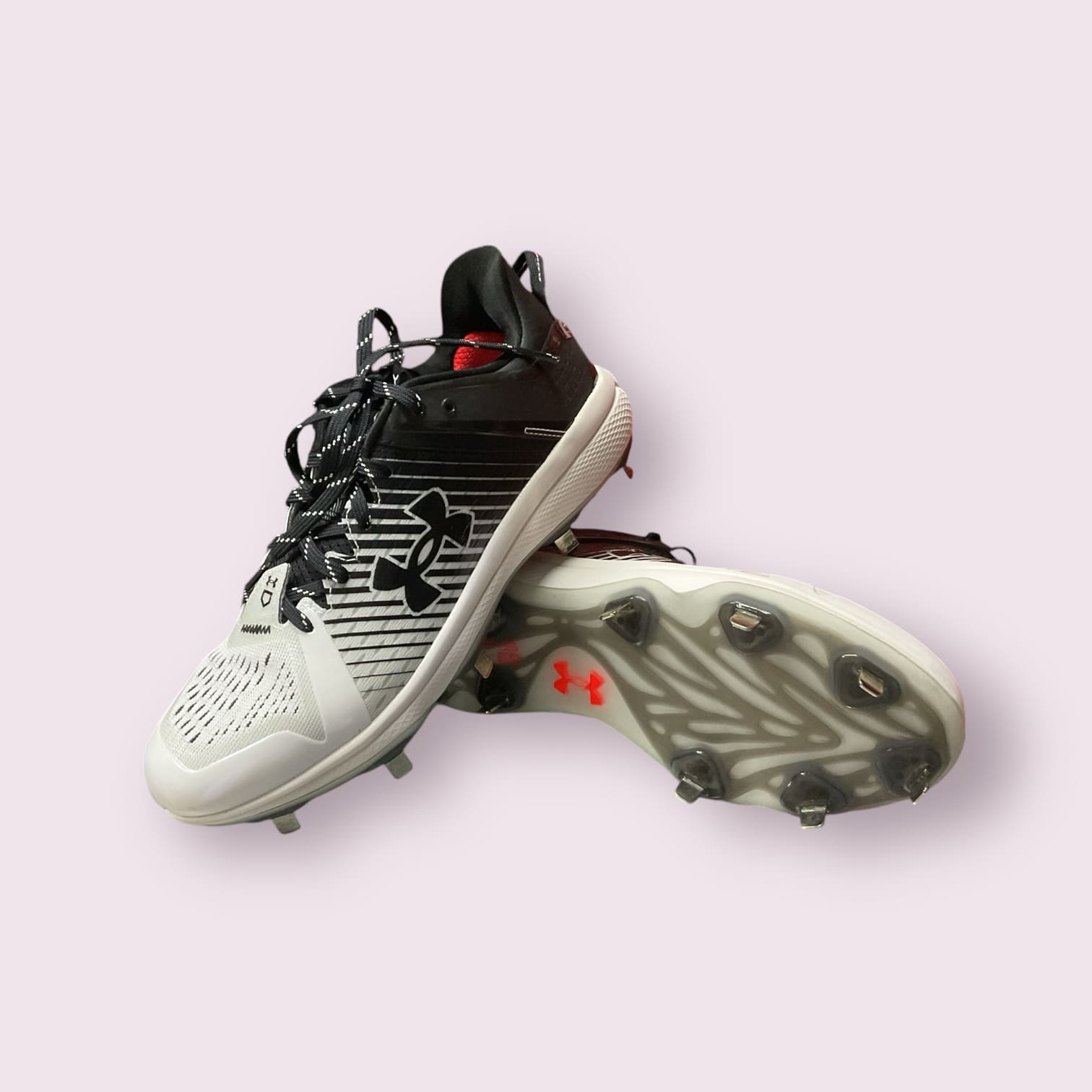 Zapatillas de béisbol UA Yard Low MT en negro y blanco, con suela de tacos, diseño ligero y bajo, ideales para rendimiento y comodidad en el campo