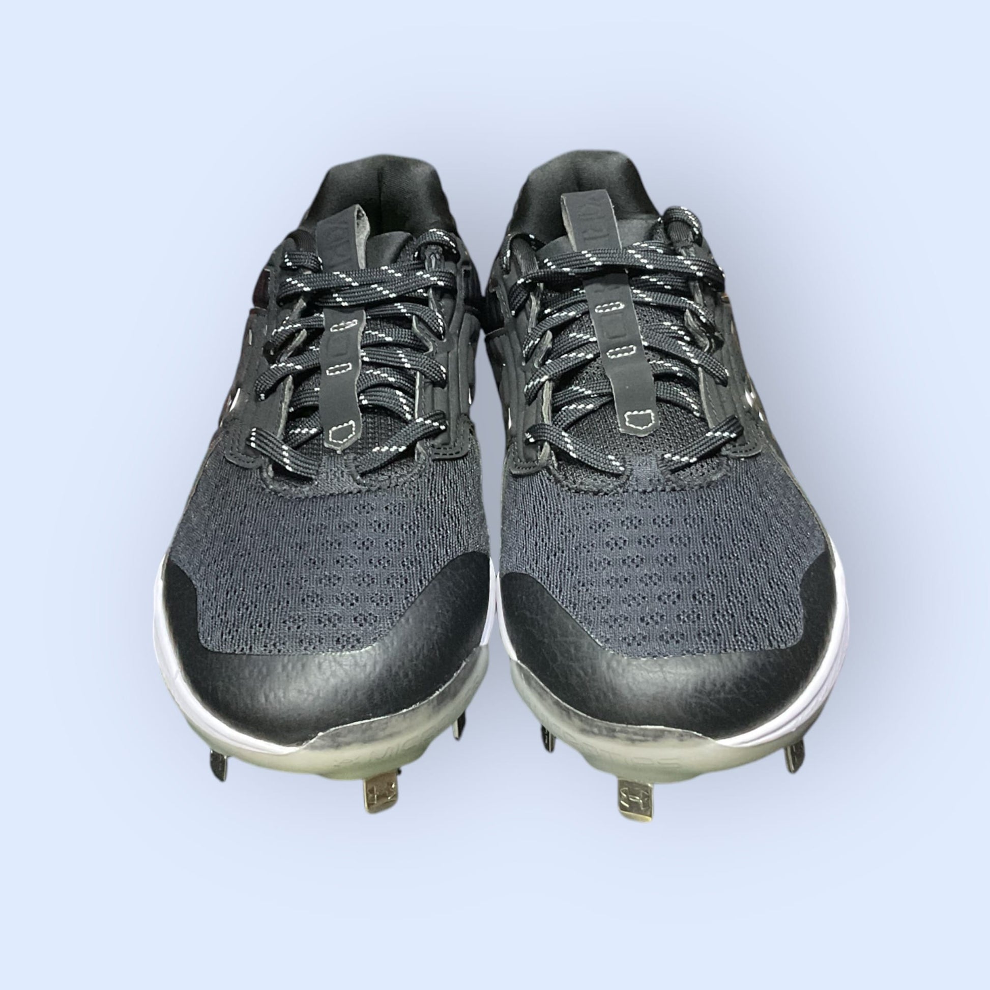 Zapatillas de béisbol UA Yard MT en negro, con suela de tacos y diseño de media altura, diseñadas para ofrecer tracción, comodidad y estabilidad en el campo