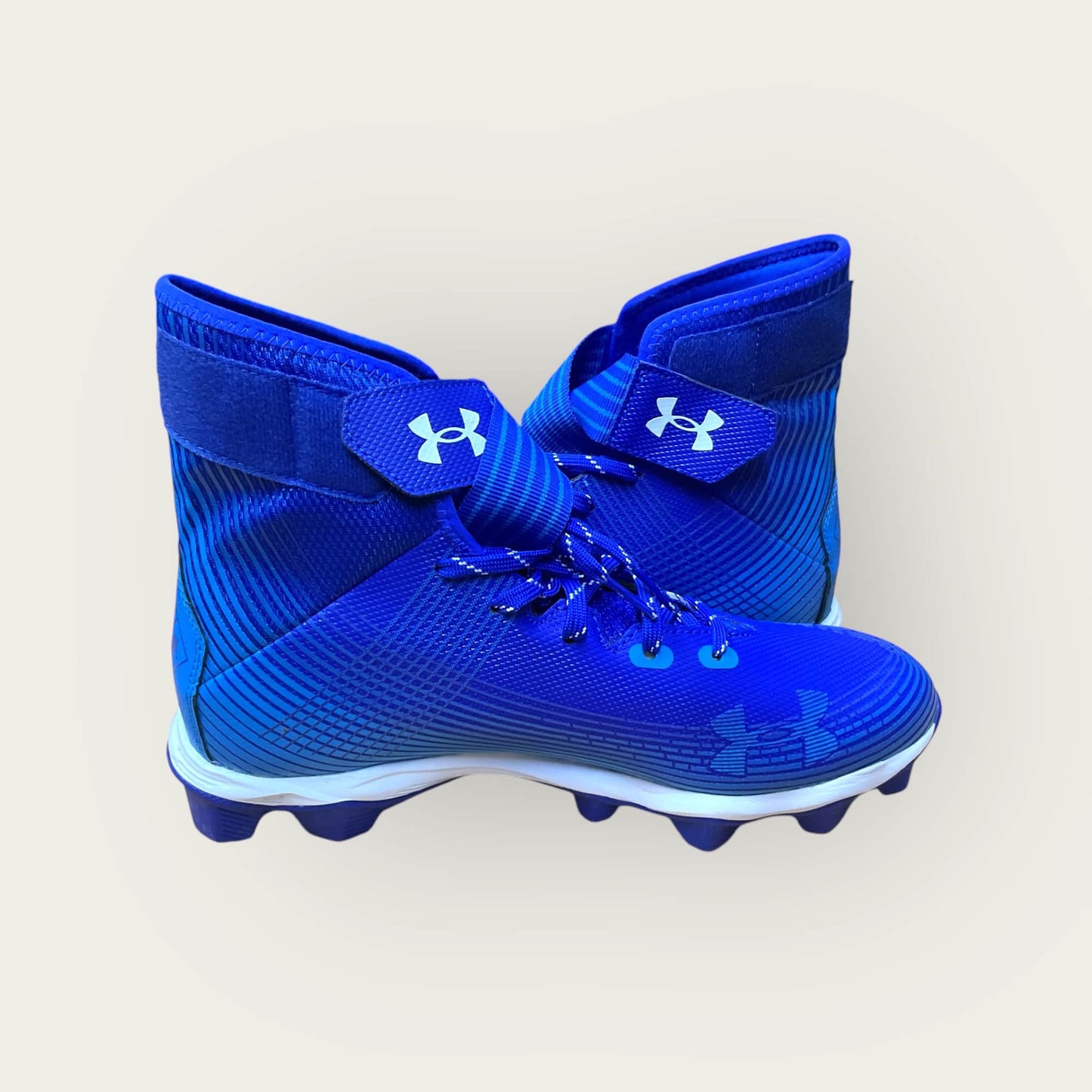 Zapatillas UA Highlight Franchise Azul con tecnología ClutchFit para fútbol y béisbol, en color azul.
